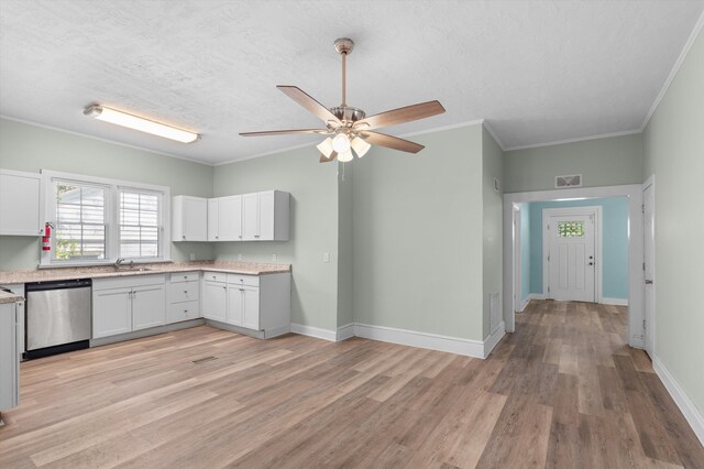1940 Telfair St, Augusta, GA 30904 - kitchen featuring stainless steel dishwasher, a sink, white cabinetry, ceiling fan, and light wood-style flooring