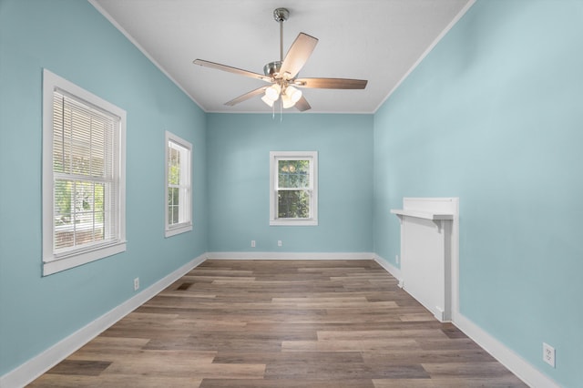 1940 Telfair St, Augusta, GA 30904 - empty room with crown molding, healthy amount of natural light, a ceiling fan, and wood finished floors