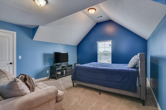 bedroom with light carpet, a textured ceiling, and vaulted ceiling