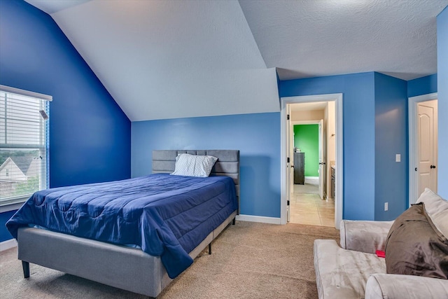 bedroom with a textured ceiling, lofted ceiling, and light carpet