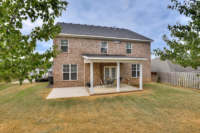 back of house featuring a yard and a patio