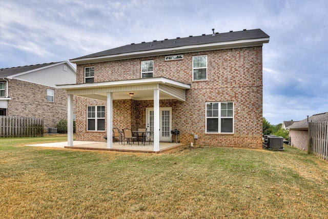 back of house featuring a patio, a lawn, and central air condition unit