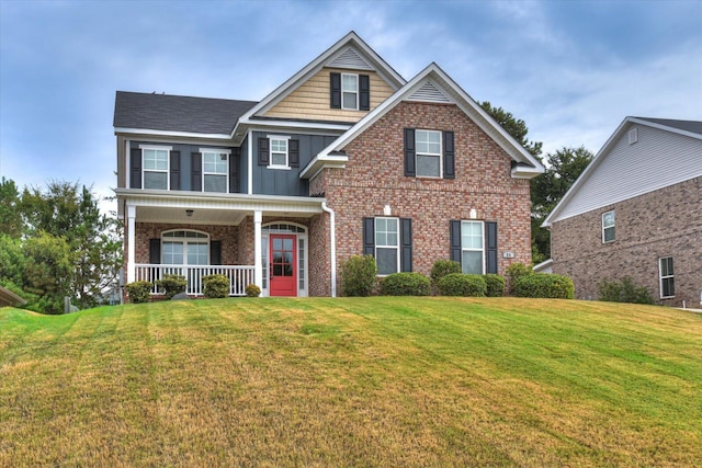 view of front of property with a front yard and a porch