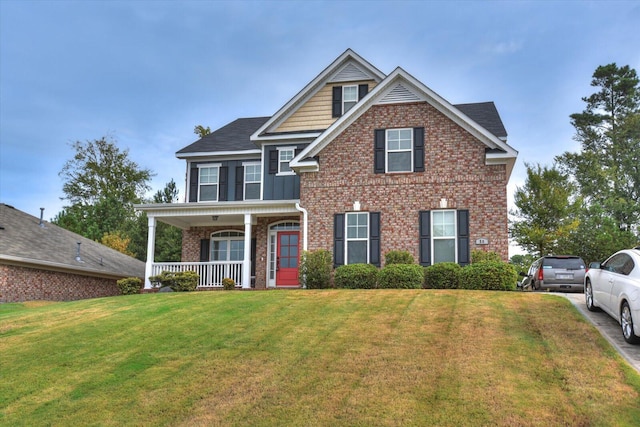 view of front of property featuring covered porch and a front yard