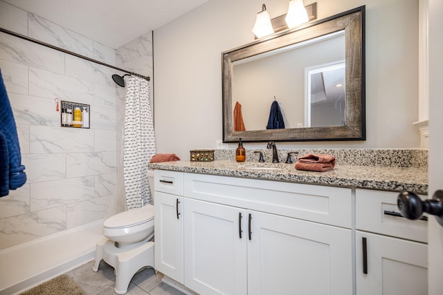 bathroom featuring vanity, curtained shower, and toilet