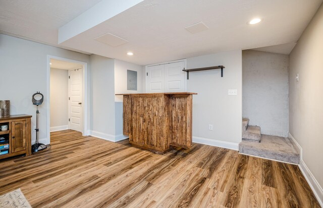 bar featuring electric panel and hardwood / wood-style floors