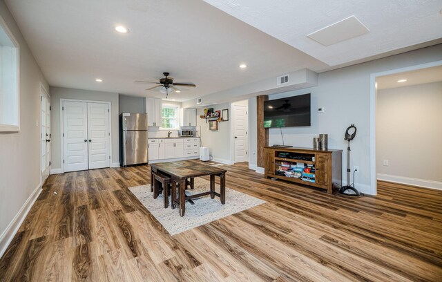 dining room with ceiling fan and wood-type flooring