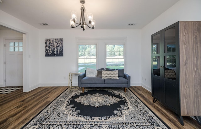 living area with hardwood / wood-style floors and a notable chandelier