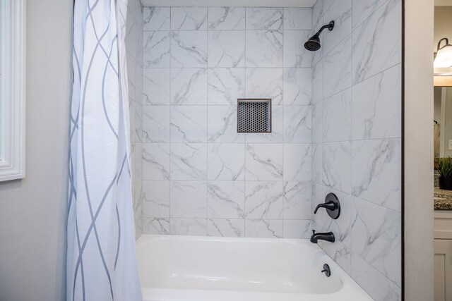 bathroom with vanity and shower / tub combo