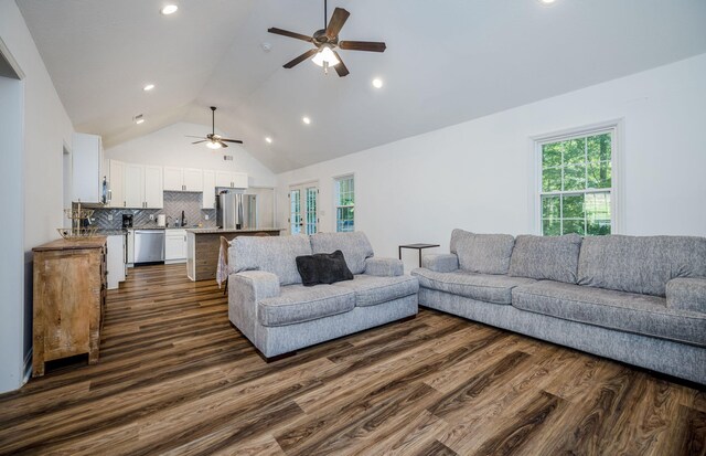 living room featuring ceiling fan, dark hardwood / wood-style floors, lofted ceiling, and sink