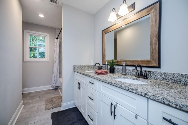 bathroom featuring tile patterned flooring, vanity, and shower / tub combo with curtain