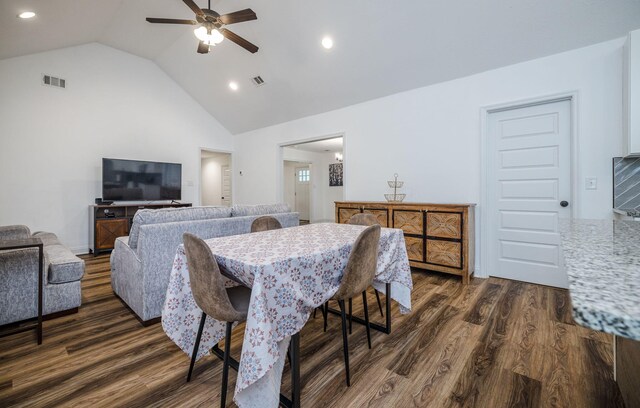 dining room with ceiling fan, dark hardwood / wood-style flooring, and vaulted ceiling