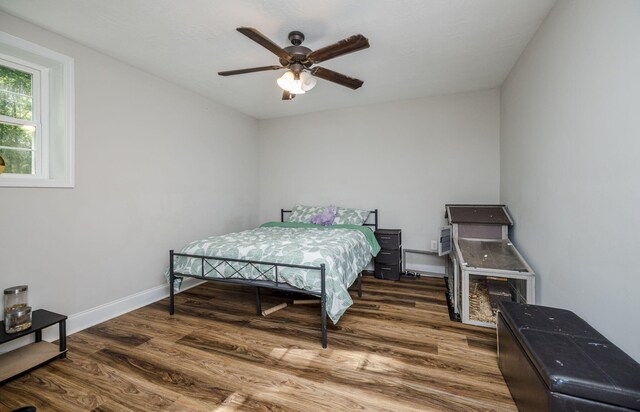 bedroom featuring ceiling fan and dark hardwood / wood-style flooring