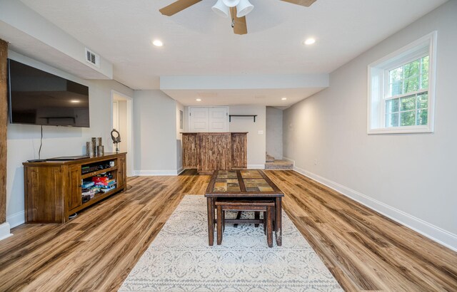 living room featuring hardwood / wood-style floors and ceiling fan