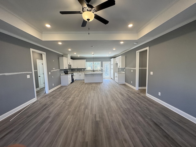 kitchen with white cabinets, stainless steel microwave, open floor plan, dark wood-type flooring, and black / electric stove