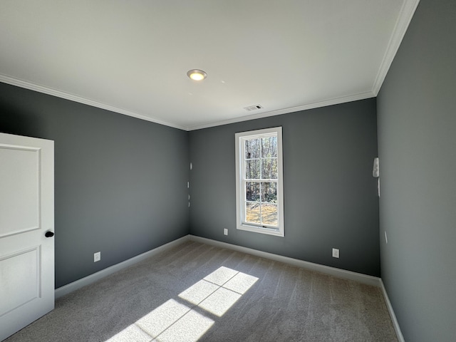 unfurnished room with crown molding, carpet floors, visible vents, and baseboards