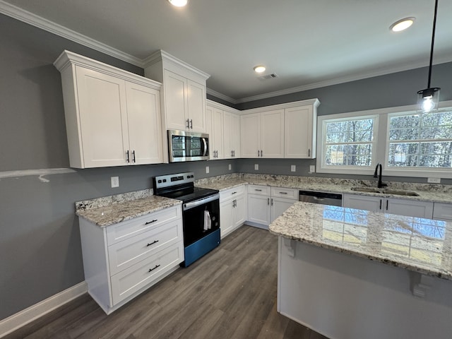 kitchen with appliances with stainless steel finishes, a sink, visible vents, and white cabinetry