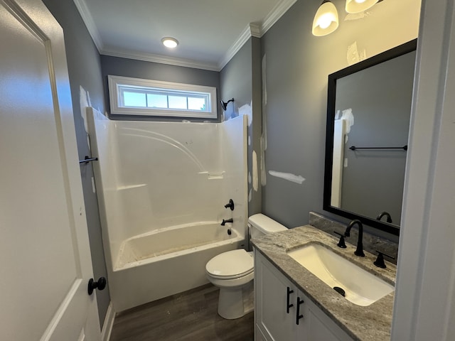 bathroom featuring bathing tub / shower combination, toilet, ornamental molding, wood finished floors, and vanity