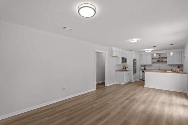 4221 Cap Chat St, Hephzibah, GA 30815 - unfurnished living room with light wood-type flooring