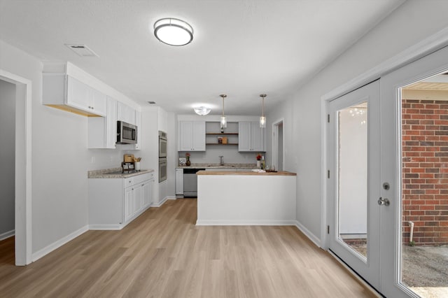 4221 Cap Chat St, Hephzibah, GA 30815 - kitchen featuring appliances with stainless steel finishes, light wood-style floors, a peninsula, white cabinetry, and light countertops