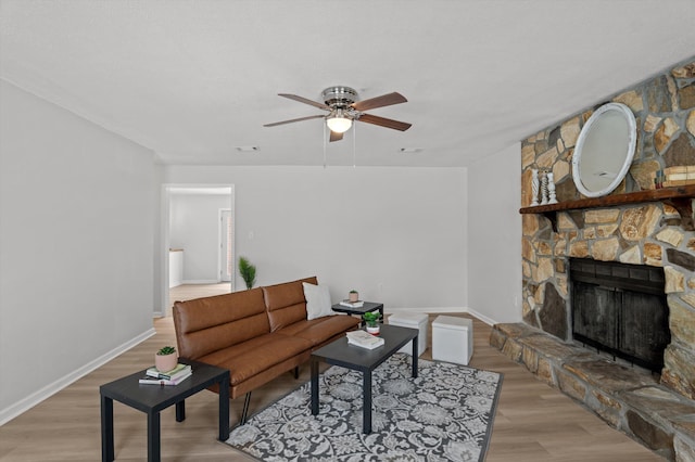 4221 Cap Chat St, Hephzibah, GA 30815 - living room featuring light wood-style floors, ceiling fan, and a stone fireplace