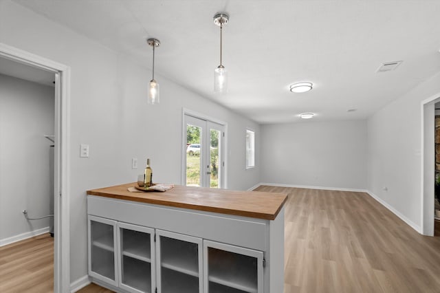 4221 Cap Chat St, Hephzibah, GA 30815 - kitchen with butcher block countertops, light wood-style flooring, and decorative light fixtures
