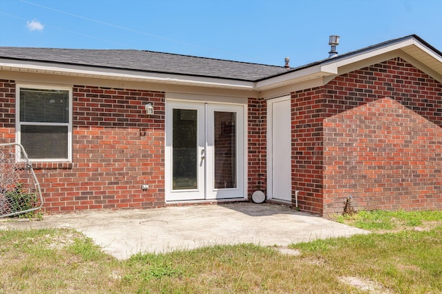 4221 Cap Chat St, Hephzibah, GA 30815 - back of property with french doors, a patio, brick siding, and roof with shingles