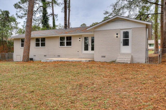 rear view of property with a yard and french doors