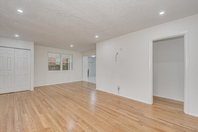 interior space featuring a textured ceiling and light hardwood / wood-style flooring