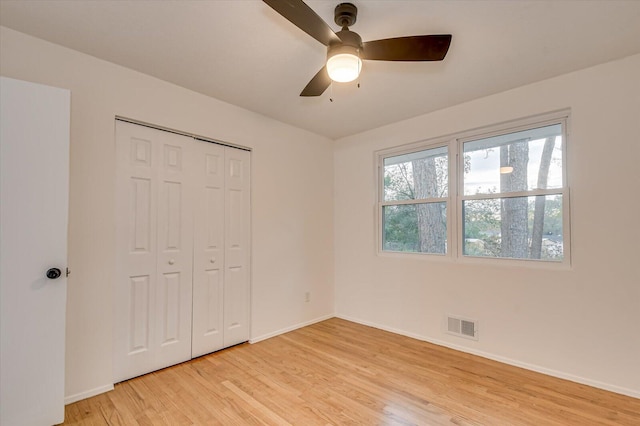 unfurnished bedroom with ceiling fan, a closet, and light hardwood / wood-style flooring