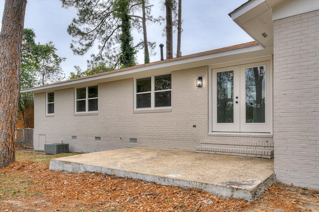 rear view of property with central AC unit and a patio area