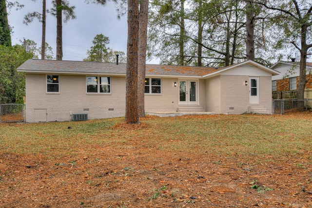 back of house featuring a yard and central AC