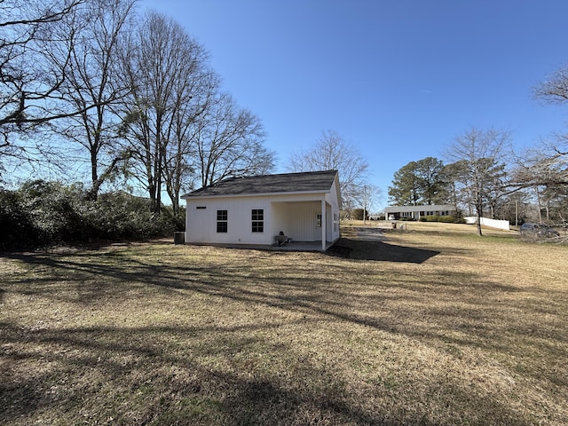 view of outbuilding featuring a yard
