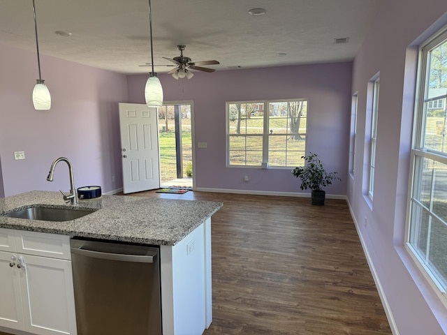 kitchen featuring white cabinetry, sink, stainless steel dishwasher, and decorative light fixtures
