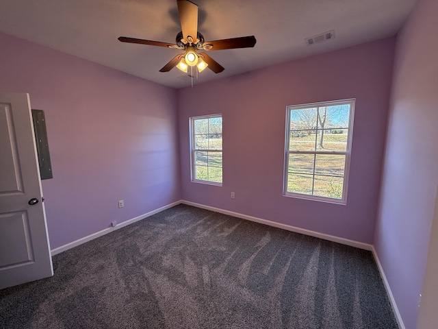 carpeted spare room with ceiling fan