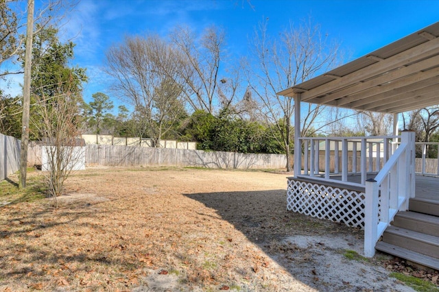 view of yard with a fenced backyard and a wooden deck