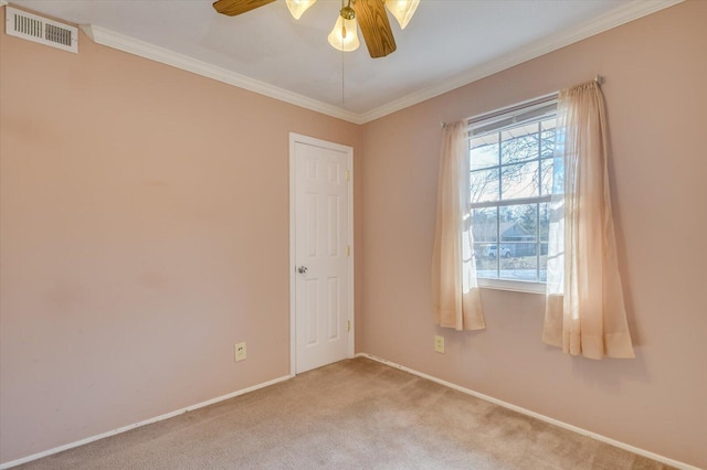 unfurnished room featuring light carpet, ornamental molding, visible vents, and a ceiling fan