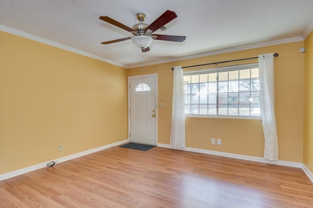 foyer featuring light wood-type flooring, baseboards, and crown molding