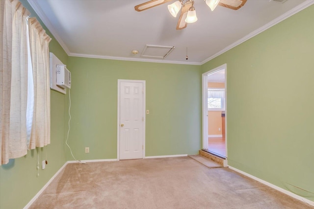 unfurnished room with light carpet, attic access, baseboards, and crown molding