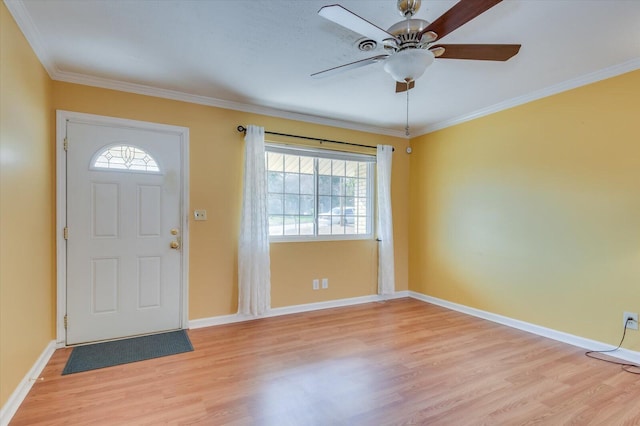 entryway featuring light wood-style floors, a healthy amount of sunlight, ornamental molding, and baseboards