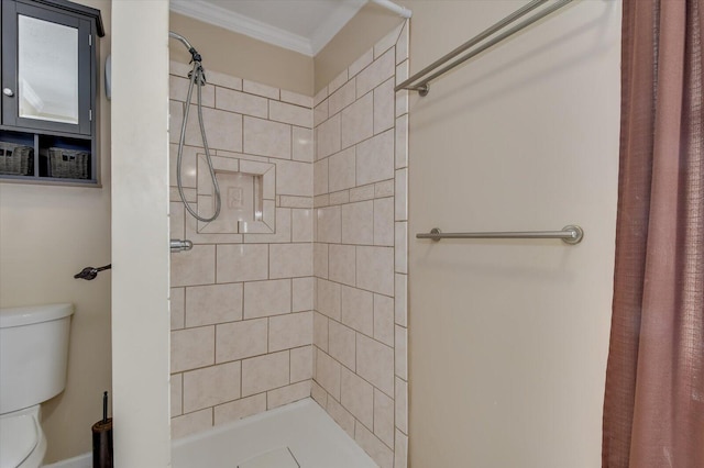 bathroom featuring toilet, a stall shower, and crown molding