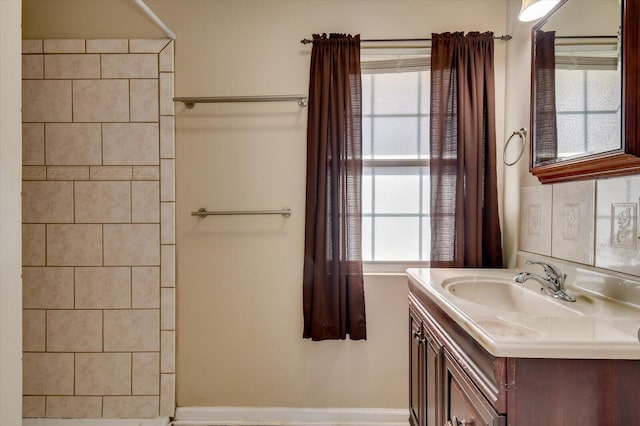 full bathroom featuring walk in shower, vanity, and a wealth of natural light