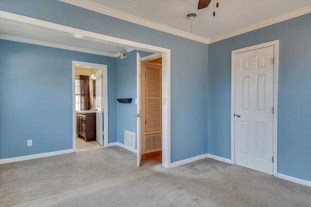 unfurnished bedroom with ornamental molding, carpet, visible vents, and baseboards