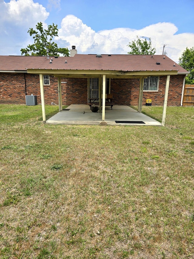 3807 Fairington Dr, Hephzibah, GA 30815 - rear view of property with brick siding, fence, a patio area, and a yard