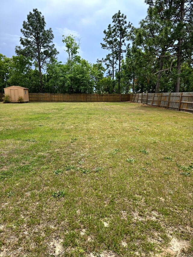 3807 Fairington Dr, Hephzibah, GA 30815 - view of yard featuring a fenced backyard, an outdoor structure, and a storage shed