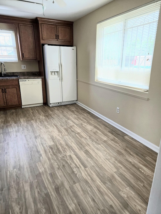 3807 Fairington Dr, Hephzibah, GA 30815 - kitchen featuring dark countertops, baseboards, a sink, and white appliances