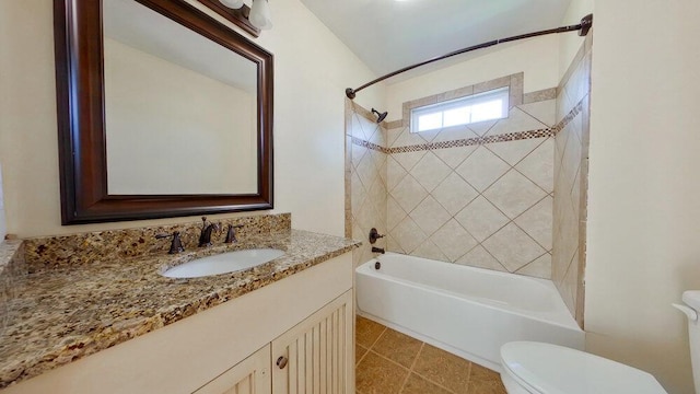 full bathroom with vanity, toilet, tiled shower / bath combo, and tile patterned flooring