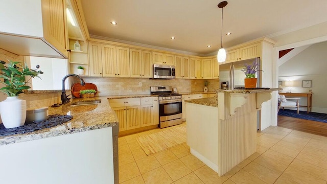 kitchen with sink, a center island, light tile patterned floors, stainless steel appliances, and light stone countertops