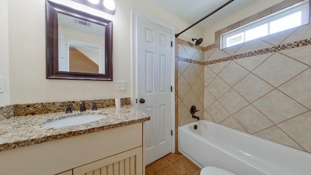 bathroom with vanity and tiled shower / bath