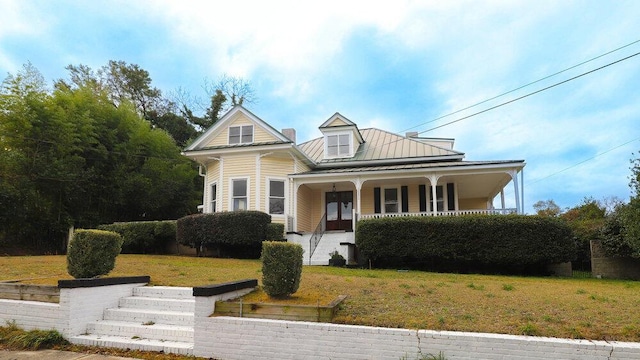 view of front of property with covered porch and a front lawn